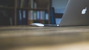 This is a laptop and a mouse on a table.