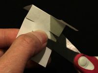 A scissor cutting the paper.