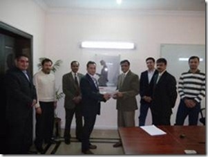 Pakistan Country Director at Acision, Mr. Salman Nayyer and Director Operations JBL, Mr. Zia ul Haque are seen exchanging documents after a contract signing, along with other team members of Acision and JBL