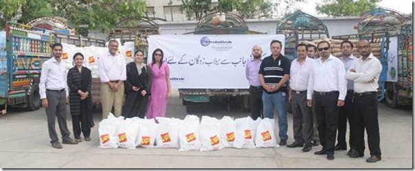 Asif Pervaiz and Khawaja Shehzadullah, Regional Directors for Mobilink South and Mobilink Foundation Torchbearers deliver relief goods for flood victims to the Pakistan Navy.