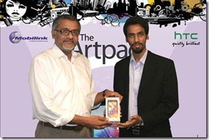 Asif Naseer Pervaiz, Director, Mobilink Customer Care Karachi (L) hands over an HTC EVO 3D to the winner of the first Mobilink Artpad competition