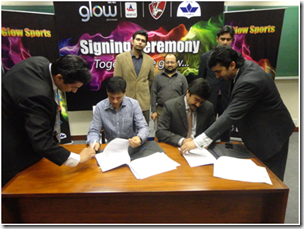 Seen in the picture from right Mr. Amer Aman Khan, Head of Sales & Distribution Warid Telecom signing documents with Dr. Ali Khan, Patron, SLUMS (Sports Society of Lahore University of Management Sciences). 