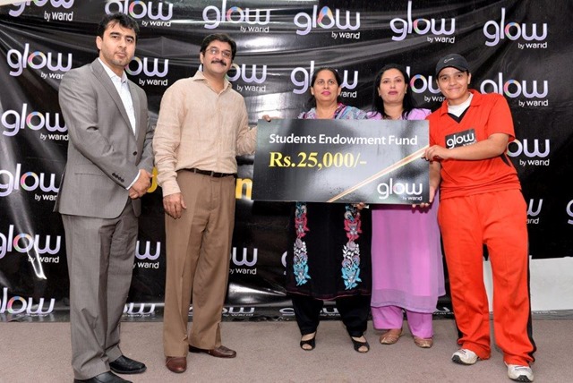 Standing from left Mr. Iqtadar Raja (Sr. Manager Trade Marketing Ops & Distribution)  and Mr. Amer Aman, Head of sales Warid Telecom while giving away cheque for Students endowment fund to LCUW.
