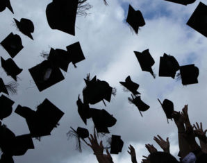 graduates throwing caps