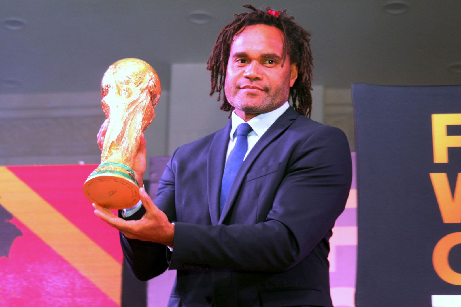 Christian Karembeu holding fifa world cup trophy 2018
