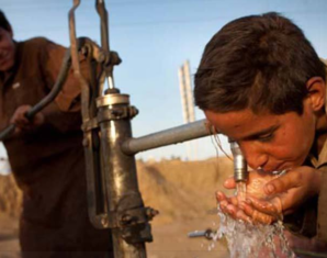 Children Drinking Water From Hand Pump in Pakistan