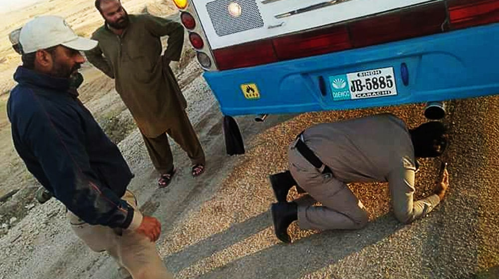 Person hiding underneath bus Karachi Peshawar