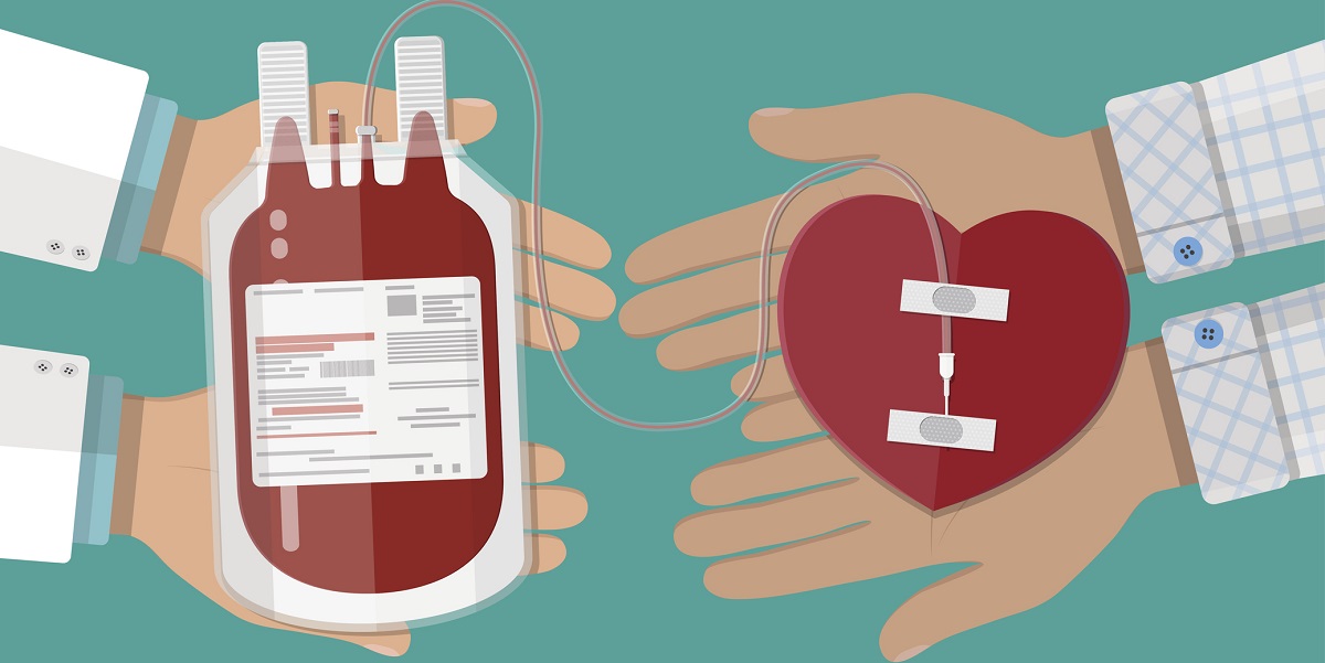 Blood bag and hand of donor with heart