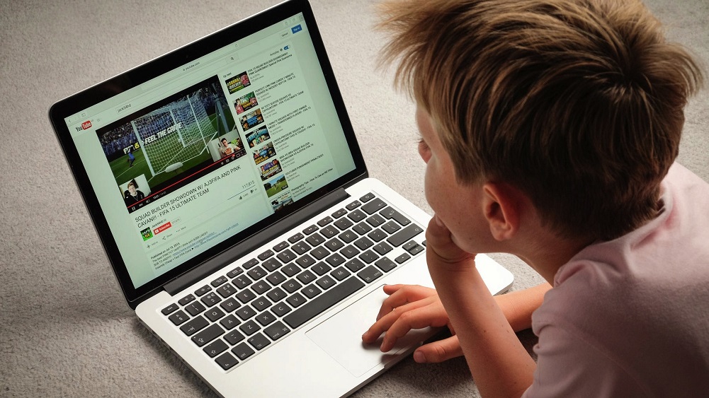 A Child watching Youtube videos on a laptop computer