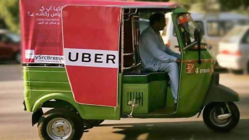 man driving uber rickshaw