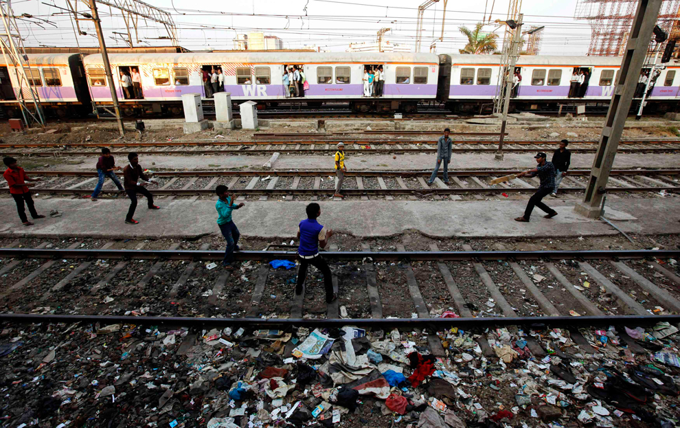 Children play cricket on railway track in mumbai