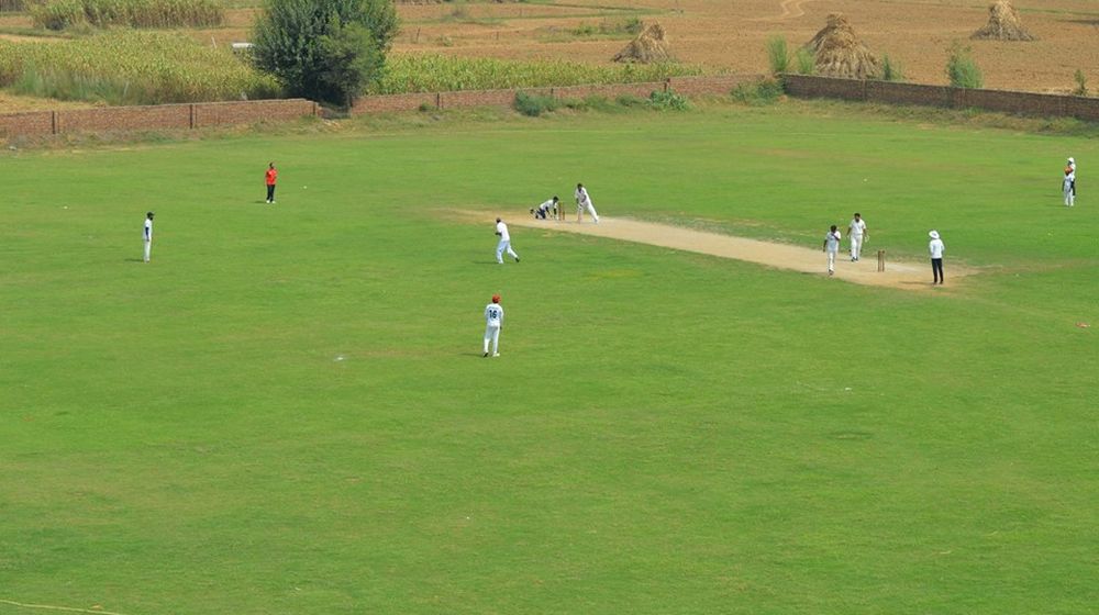 Players playing at a local cricket ground