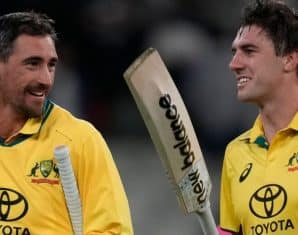 Mitchell Starc and Pat Cummins walk off after the win