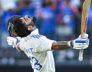 Virat Kohli celebrates scoring his 30th century
