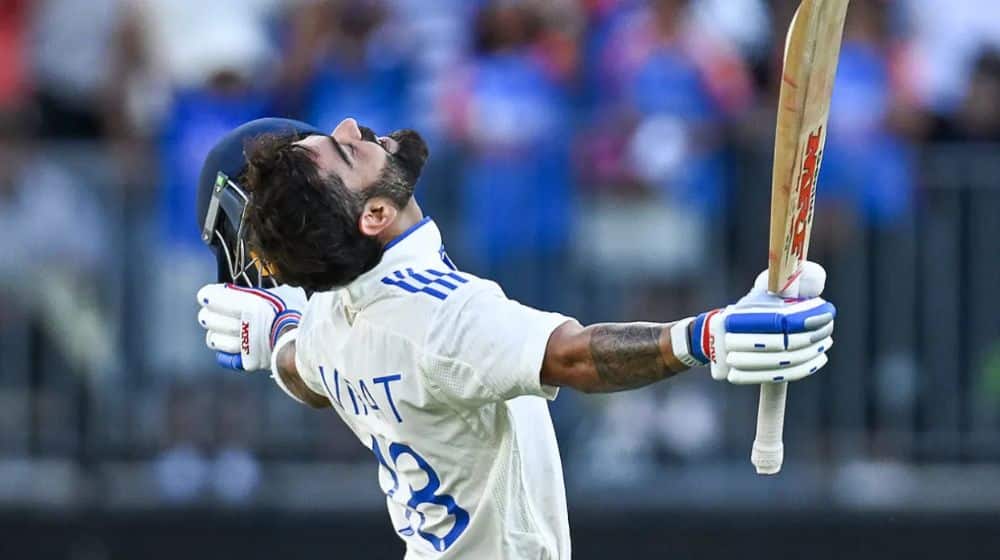 Virat Kohli celebrates scoring his 30th century