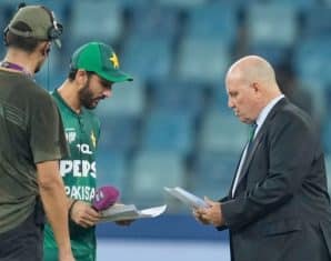 Andy Pycroft and Salman Ali Agha during an exchange before the toss